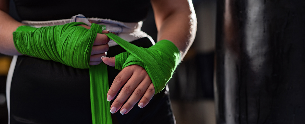 A woman's hand delicately nurtures a green plant, symbolizing growth, love, and life, much like a wedding flower.